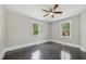 Bedroom featuring two windows letting in ample natural light and dark wood flooring at 1331 Sunset Ave, Rocky Mount, NC 27804