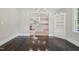 Charming dining area with wood floors, built-in shelving, and a glimpse into the modern kitchen at 1331 Sunset Ave, Rocky Mount, NC 27804