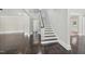 Entryway features stairs with black banister and dark wood floors extending into the living room at 1331 Sunset Ave, Rocky Mount, NC 27804