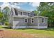 Exterior shot shows gray home with white foundation and neatly manicured lawn at 1331 Sunset Ave, Rocky Mount, NC 27804
