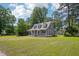 Inviting home with a spacious front yard, a classic covered porch, and lush green surroundings at 1331 Sunset Ave, Rocky Mount, NC 27804