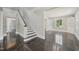 Elegant foyer with wood floors, white staircase, and natural light from adjacent room windows at 1331 Sunset Ave, Rocky Mount, NC 27804