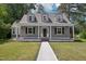 Charming home featuring gray siding, a welcoming front porch, and manicured green lawn with a concrete walkway at 1331 Sunset Ave, Rocky Mount, NC 27804