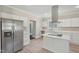 Open kitchen with island cooktop, stainless refrigerator, and quartz countertops at 1331 Sunset Ave, Rocky Mount, NC 27804