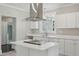 Modern kitchen with white cabinets, stainless steel appliances, and an island with a cooktop at 1331 Sunset Ave, Rocky Mount, NC 27804