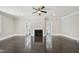 Spacious living room featuring a fireplace, a ceiling fan, and pristine hardwood floors at 1331 Sunset Ave, Rocky Mount, NC 27804