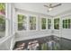 Sunroom featuring fan, multiple windows, original floors and neutral wall paint at 1331 Sunset Ave, Rocky Mount, NC 27804