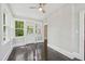Enclosed sunroom features original hardwood flooring, ceiling fan, and bright natural light at 1331 Sunset Ave, Rocky Mount, NC 27804