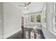 Sunroom with ceiling fan, hardwood floors, and exterior views from three large windows at 1331 Sunset Ave, Rocky Mount, NC 27804