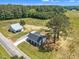 An aerial view shows the home, a garage, and the expansive yard with surrounding trees and foliage at 1347 Crocker Rd, Smithfield, NC 27577