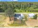 An aerial view of a cozy single-Gathering home with a metal shed surrounded by lush greenery and open land at 1347 Crocker Rd, Smithfield, NC 27577
