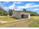 Barn on a property featuring weathered wood siding, a metal roof, and a large opening for vehicle storage at 1347 Crocker Rd, Smithfield, NC 27577