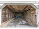 Rustic barn interior featuring gravel floor, weathered wood walls, and a blue barrel at 1347 Crocker Rd, Smithfield, NC 27577