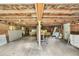 The unfinished basement features exposed wooden beams and a variety of stored items at 1347 Crocker Rd, Smithfield, NC 27577