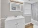 Bathroom featuring a white vanity, modern fixtures, and a shower-tub combo with a patterned shower curtain at 1347 Crocker Rd, Smithfield, NC 27577