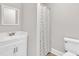 Bathroom featuring a large, well lit vanity and sink, mirror, toilet and shower with curtain at 1347 Crocker Rd, Smithfield, NC 27577