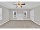 Spacious bedroom features neutral walls, plush carpet, bright windows, and a stylish ceiling fan at 1347 Crocker Rd, Smithfield, NC 27577