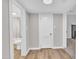 Hallway that features hardwood floors, neutral walls, and access to the bathroom and a room with a fireplace at 1347 Crocker Rd, Smithfield, NC 27577