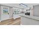 A well-lit kitchen boasts wood-look floors, white cabinets, and granite counters, with backyard access at 1347 Crocker Rd, Smithfield, NC 27577