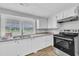White cabinets, granite countertops, and stainless appliances create a bright and functional kitchen space at 1347 Crocker Rd, Smithfield, NC 27577