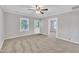 An inviting living room featuring neutral colors, a ceiling fan, and large windows at 1347 Crocker Rd, Smithfield, NC 27577