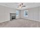 Spacious living room with a gray brick fireplace, ceiling fan, neutral walls, and carpet floors at 1347 Crocker Rd, Smithfield, NC 27577
