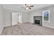 Spacious living room with a gray brick fireplace, carpet floors, and neutral walls with windows at 1347 Crocker Rd, Smithfield, NC 27577