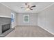 Spacious living room with a gray brick fireplace, ceiling fan, neutral walls, and plenty of natural light at 1347 Crocker Rd, Smithfield, NC 27577