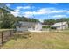 A view of the back of the home, featuring a detached garage and a small wooden deck at 1347 Crocker Rd, Smithfield, NC 27577
