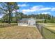 A view of the rear exterior, featuring a deck, a carport, and a chain link fence at 1347 Crocker Rd, Smithfield, NC 27577