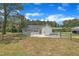 A view of the rear exterior with the deck, carport, and a chain link fence at 1347 Crocker Rd, Smithfield, NC 27577