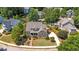 Beautiful aerial view of home with manicured lawn, mature landscaping, and circular driveway at 1437 Chelton Oaks Pl, Raleigh, NC 27614