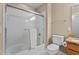 Clean bathroom featuring a shower over tub with glass door, neutral tiles, and modern fixtures for a fresh and updated look at 1437 Chelton Oaks Pl, Raleigh, NC 27614