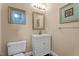Bright powder room features a white vanity, a modern sink, and decorative wall art at 1437 Chelton Oaks Pl, Raleigh, NC 27614