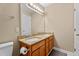 Bright bathroom features a double sink vanity with granite countertops and a large mirror at 1437 Chelton Oaks Pl, Raleigh, NC 27614