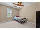 Cozy bedroom features a ceiling fan, a twin bed with quilt, and natural light for a relaxing atmosphere at 1437 Chelton Oaks Pl, Raleigh, NC 27614
