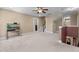 Spacious bonus room with neutral carpet, a small fish tank, and a staircase leading to another level of the home at 1437 Chelton Oaks Pl, Raleigh, NC 27614