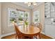 Inviting breakfast nook with a wood table, chairs, and lots of natural light from the surrounding windows at 1437 Chelton Oaks Pl, Raleigh, NC 27614