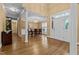Elegant dining room featuring hardwood floors, tray ceiling, and stylish chandelier near the home's entry at 1437 Chelton Oaks Pl, Raleigh, NC 27614