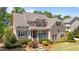 Charming two-story home with a welcoming front porch and nicely landscaped front yard, perfect for curb appeal at 1437 Chelton Oaks Pl, Raleigh, NC 27614