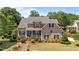 Charming two-story home with a welcoming front porch and beautifully landscaped front yard with mature trees at 1437 Chelton Oaks Pl, Raleigh, NC 27614