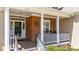 Inviting front porch with white columns, brick accents, and a cozy seating area perfect for relaxing outdoors at 1437 Chelton Oaks Pl, Raleigh, NC 27614