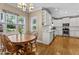 Charming kitchen with white cabinets, breakfast nook, and lots of natural light from the surrounding windows at 1437 Chelton Oaks Pl, Raleigh, NC 27614