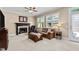 Comfortable living room with a fireplace, plush sofa, and ceiling fan for a relaxing atmosphere at 1437 Chelton Oaks Pl, Raleigh, NC 27614