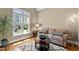 Cozy living area with a comfortable sofa, round coffee table on a patterned rug and a sunlit window at 1437 Chelton Oaks Pl, Raleigh, NC 27614