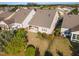 An aerial view of homes with backyard patios surrounded by mature trees and lush landscaping at 1522 Palmer Hill Dr, Durham, NC 27703