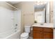 Comfortable bathroom featuring a sleek vanity and a shower-tub combo, perfect for relaxation at 1522 Palmer Hill Dr, Durham, NC 27703