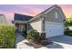 Charming home featuring a two-car garage, well-maintained landscaping, and a welcoming entrance at 1522 Palmer Hill Dr, Durham, NC 27703