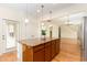 Stylish kitchen island featuring granite countertops, wooden cabinets, and pendant lighting at 1522 Palmer Hill Dr, Durham, NC 27703