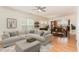 Spacious living room with hardwood floors, a large comfy sofa and a seamless connection to the dining area and kitchen at 1522 Palmer Hill Dr, Durham, NC 27703